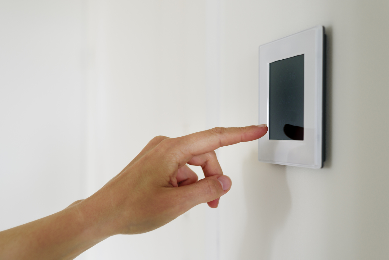 Hand using Air ventilation controller panel with display at home. Smart house system
