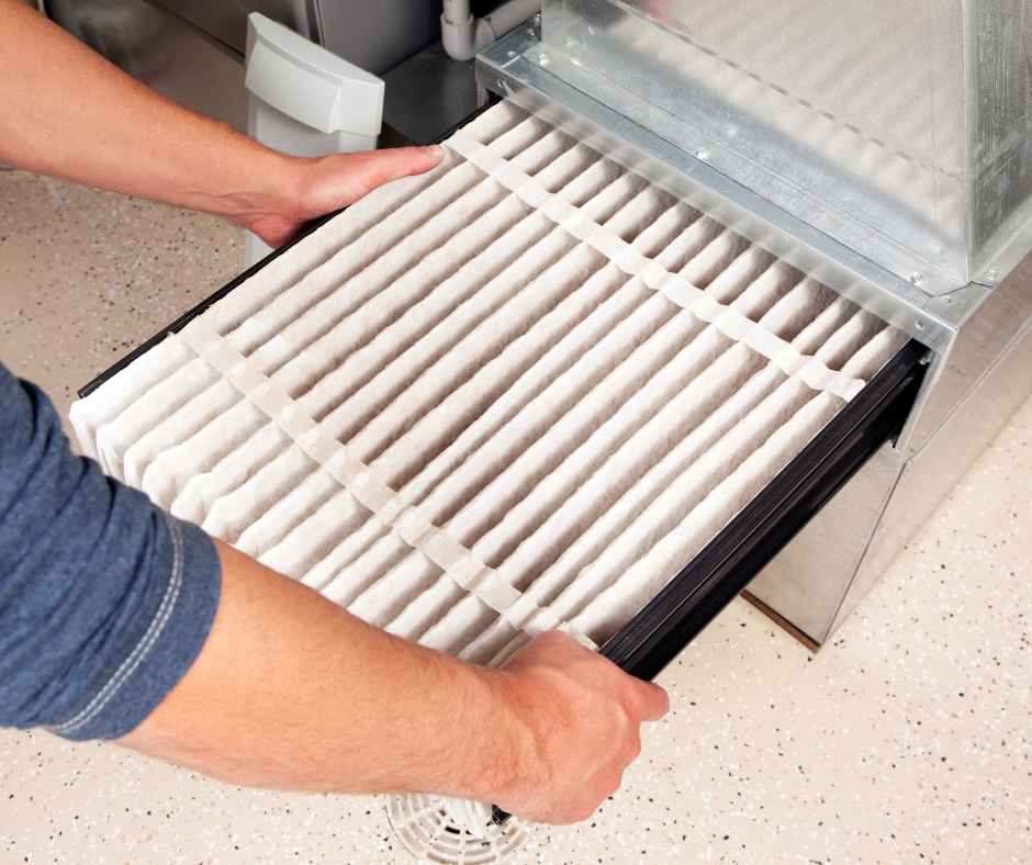 A man changing a furnace filter