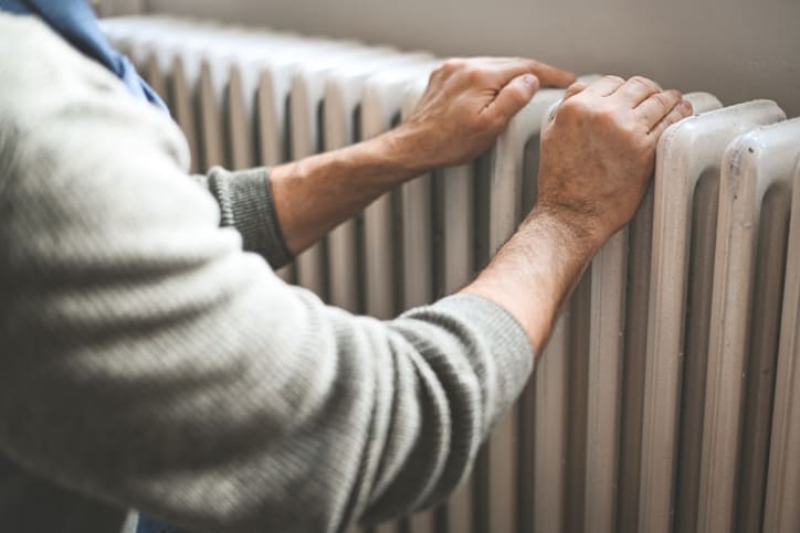 Senior Man Near Home Radiator