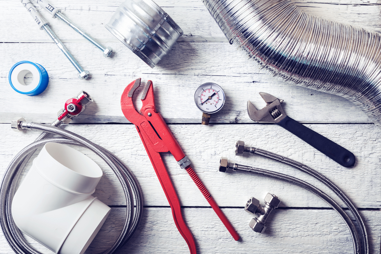 Plumbing Tools on Wooden Table